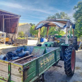 Ein Traktor mit Anhänger auf dem Hofgelände in Pulsitz